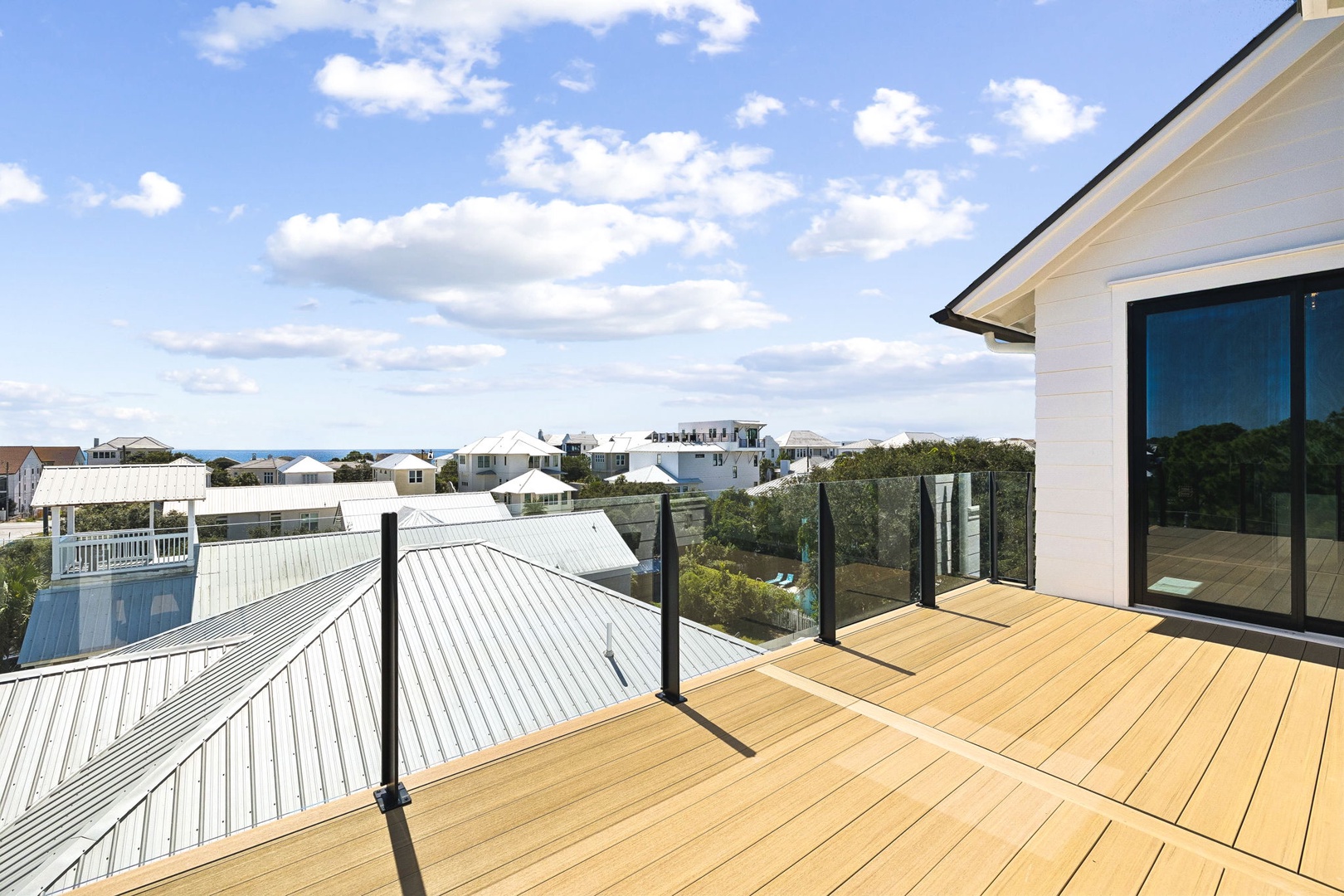 A stunning rooftop terrace perched above the neighborhood, where you can soak in coastal breezes, bright skies, and a peaceful ocean view framing your coastal escape.