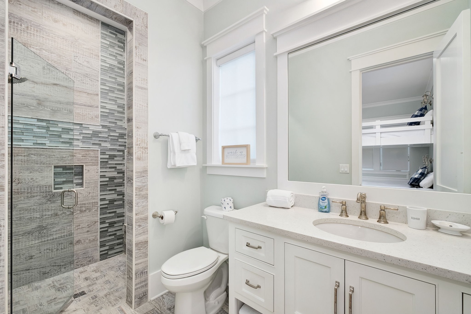 Your private spa-like bathroom features elegant tile work, a spacious glass shower, and premium amenities for ultimate relaxation.