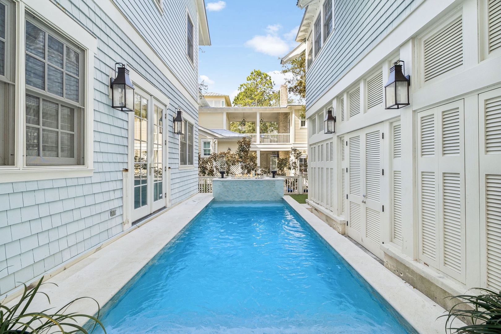 Your private pool awaits between charming coastal buildings, creating a peaceful oasis where you can unwind in crystal-clear waters.