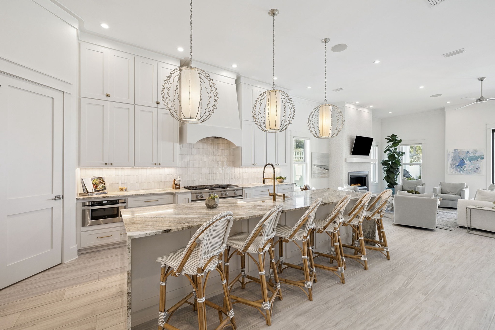Gather around this stunning kitchen island where elegant pendant lights illuminate your culinary adventures and conversations flow as naturally as the open layout.