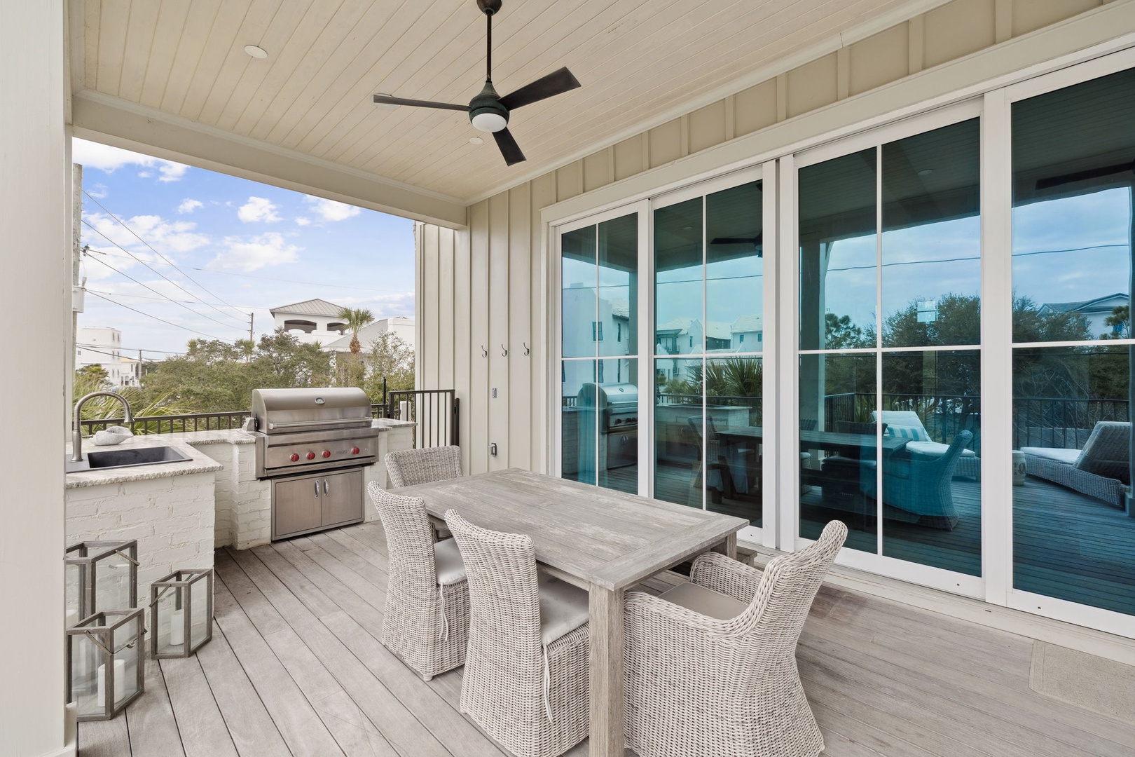 Dine al fresco under your private covered terrace, where the ceiling fan keeps you cool and panoramic windows showcase your elegant indoor living space.