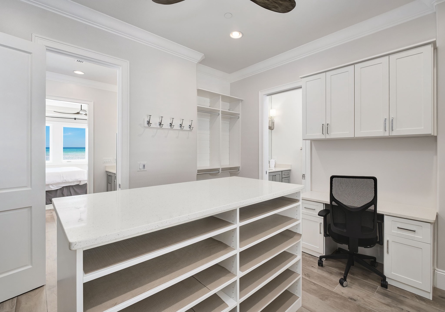This organized workspace keeps you productive with built-in storage, marble counter, and glimpses of ocean views from the adjoining bedroom.