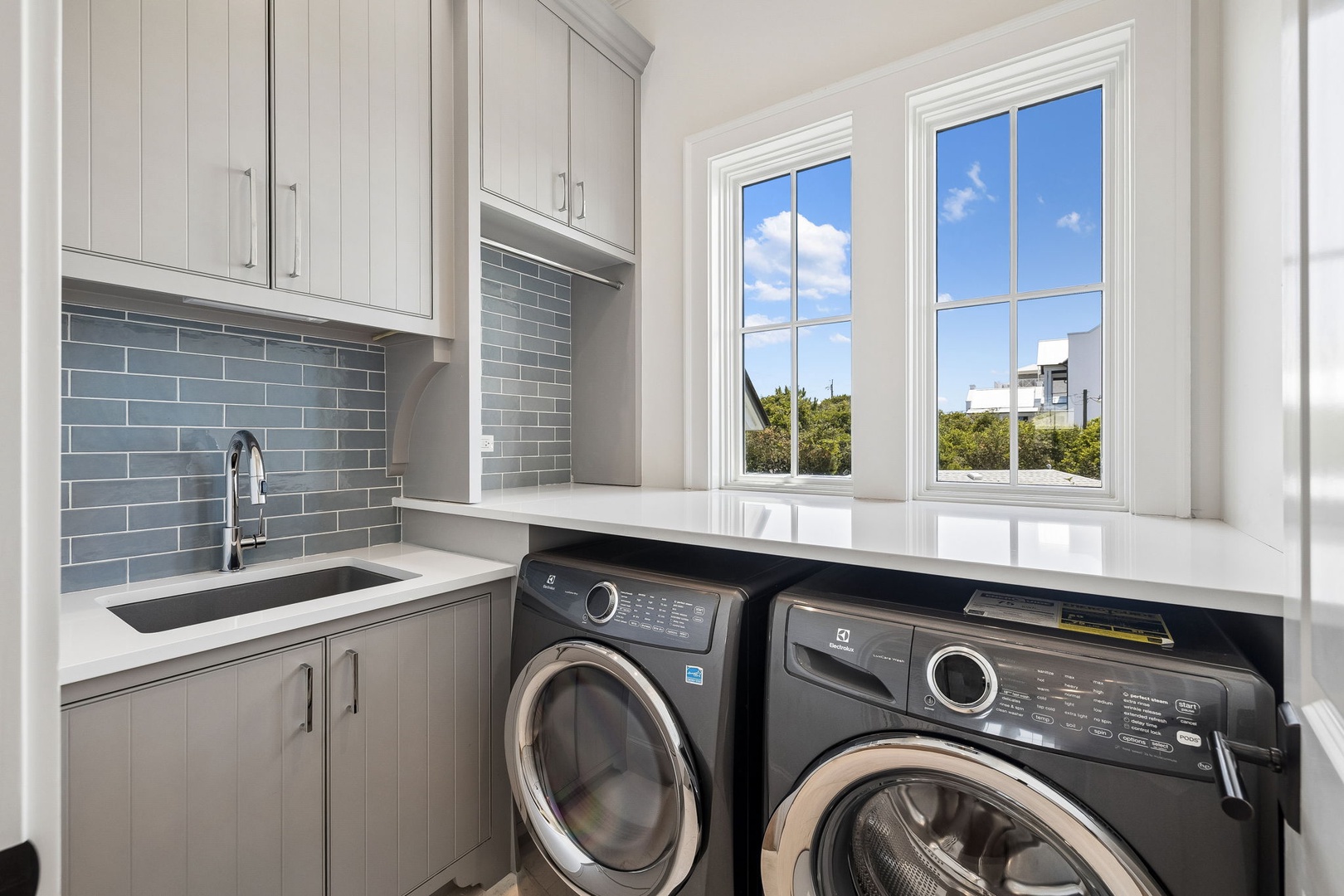 Your dedicated laundry space makes packing light effortless, with modern appliances, a handy sink, and ample cabinetry for storing essentials while you enjoy your stay.