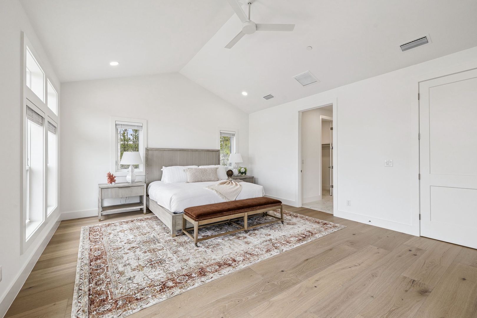 Drift off to peaceful sleep in your bright, airy bedroom with vaulted ceilings and elegant hardwood floors that create the perfect retreat.