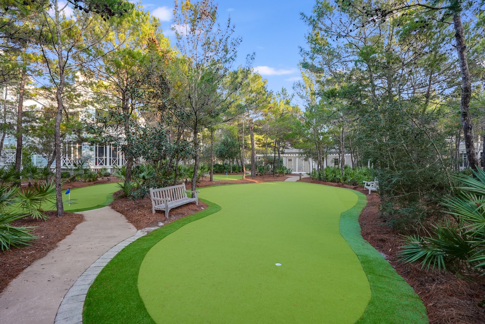 The property features a private putting green nestled among towering pines and landscaped gardens, ideal for leisurely outdoor recreation during your stay.