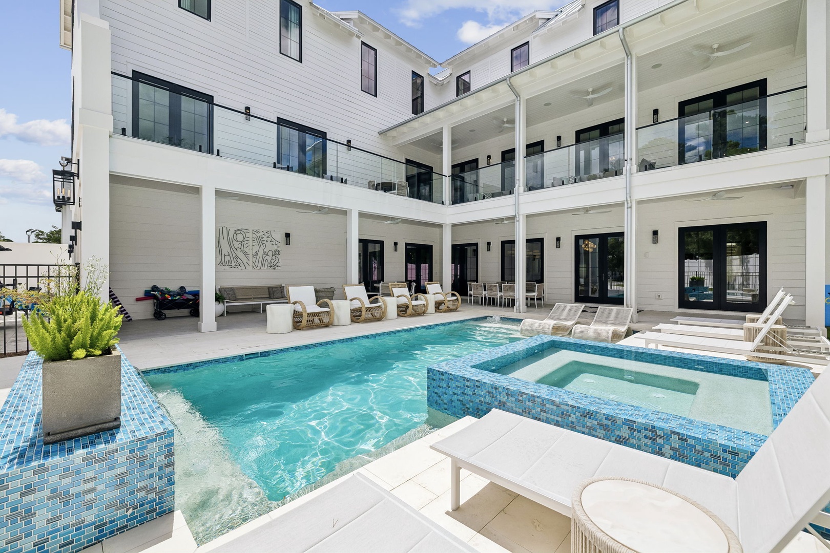 Gorgeous courtyard pool and spa where you can soak up the sun on plush loungers or unwind in the hot tub, all surrounded by modern architecture and covered seating areas.