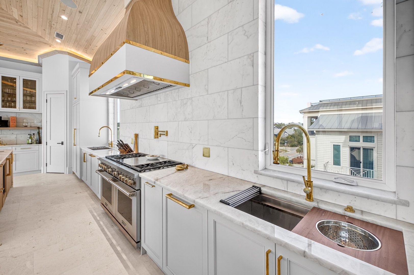 Your gourmet kitchen awaits with marble countertops, professional-grade appliances, and gold accents creating an elegant culinary experience.