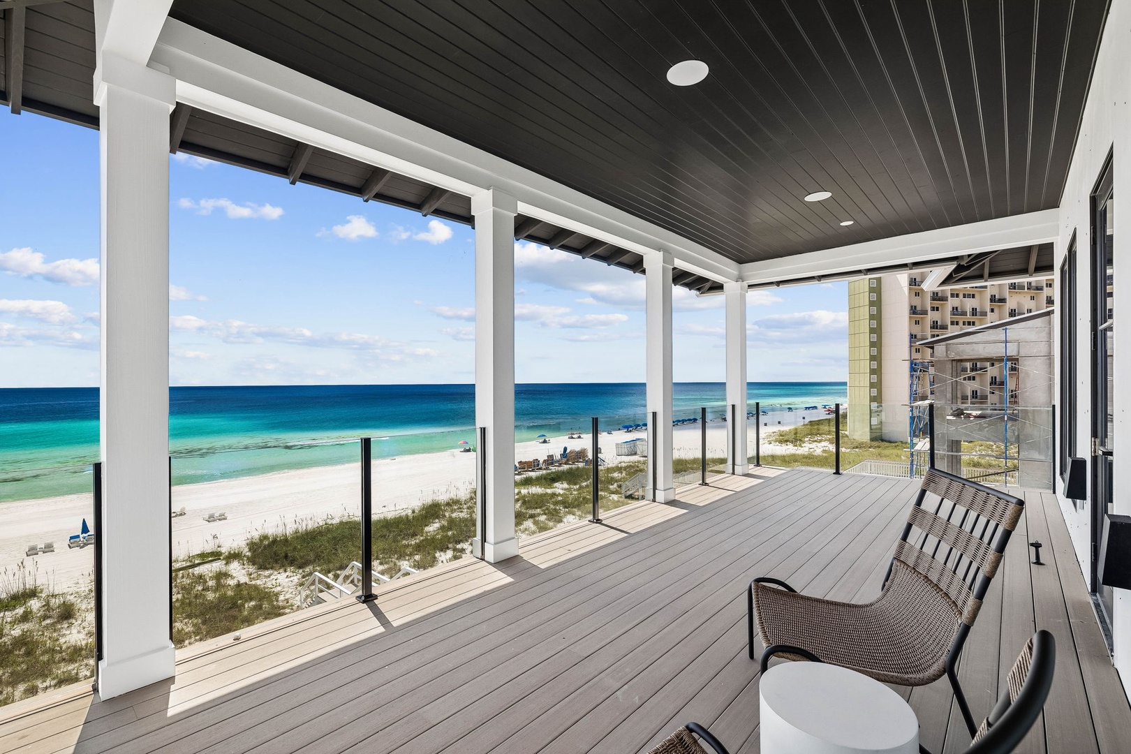Relax on your private covered deck with stunning turquoise waters and soft white sand stretching before you. This modern coastal retreat offers the perfect perch to watch waves roll in.