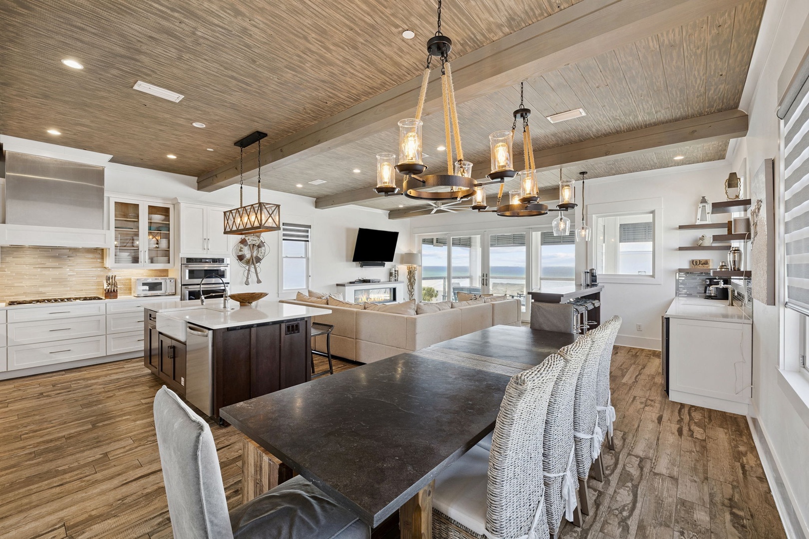 Your gourmet kitchen features stunning beamed ceilings, premium appliances, and a spacious island perfect for cooking memorable meals together.