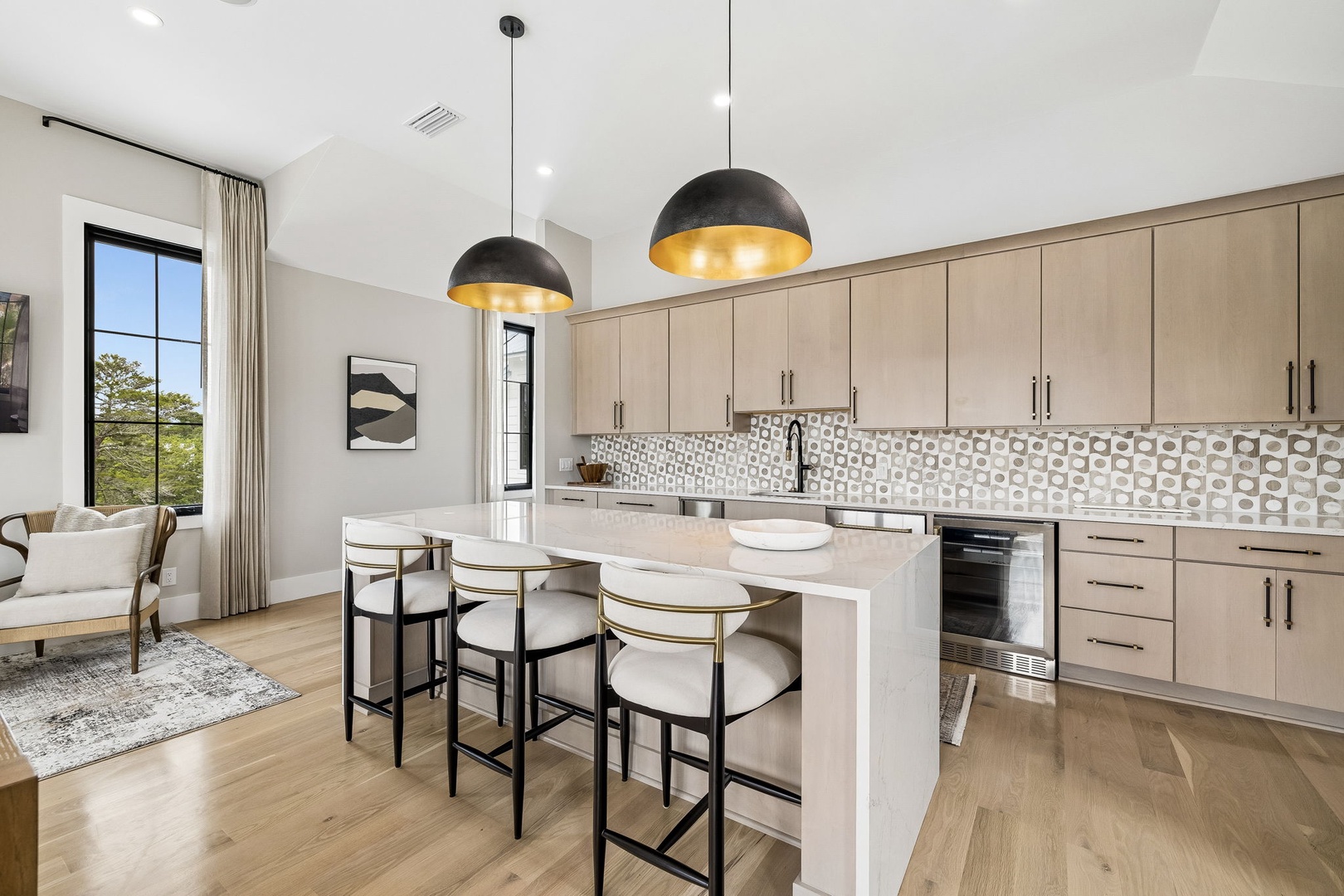 Gather around your island to cook and connect, where modern design meets warm elegance. Natural light floods your open kitchen, highlighting chic pendant lighting and stylish finishes.