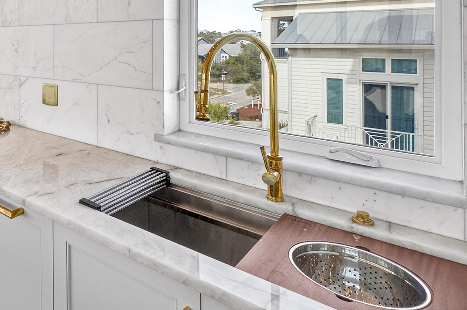 Your luxurious kitchen features stunning marble countertops, gleaming gold fixtures, and a professional sink perfect for culinary adventures.