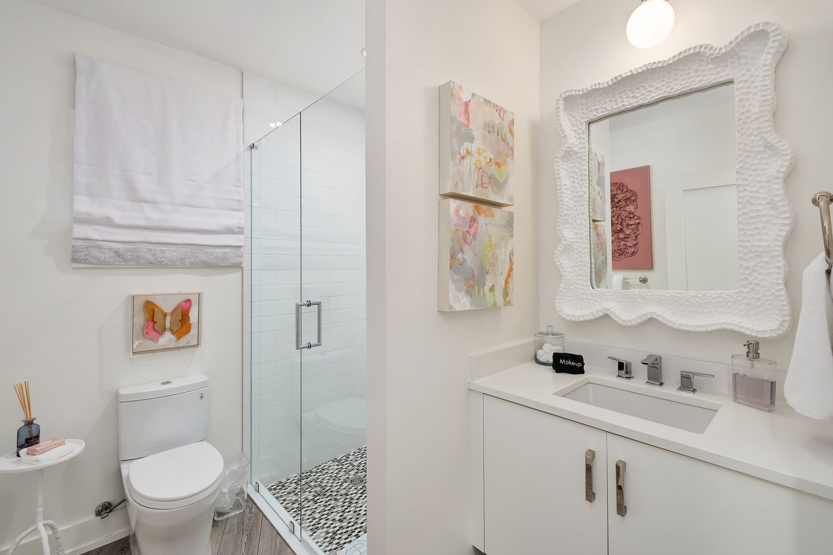 Step into your private, beautifully styled bathroom with a walk-in shower, elegant fixtures, and artistic touches that make freshening up feel like a retreat.