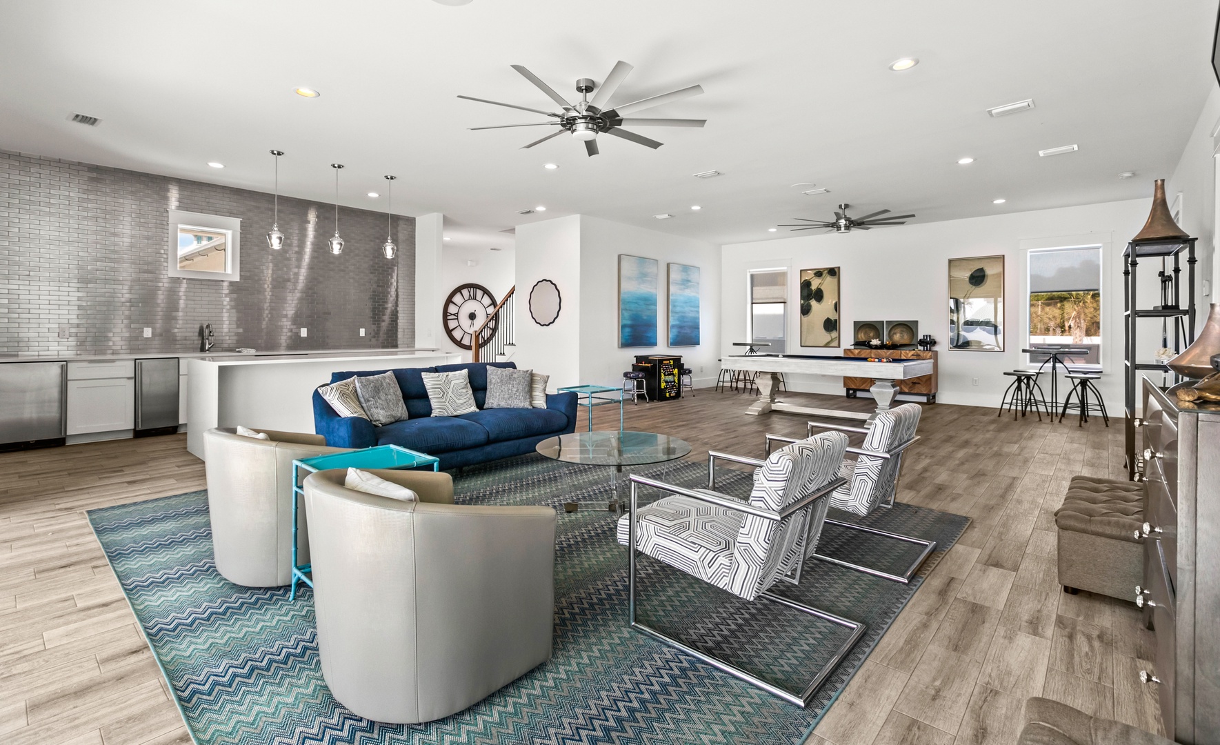 Settle into a modern, open-concept living space designed for connection. Your group can gather around sleek furnishings and enjoy the natural light streaming through expansive windows, with a fully-equipped kitchen ready for any occasion.