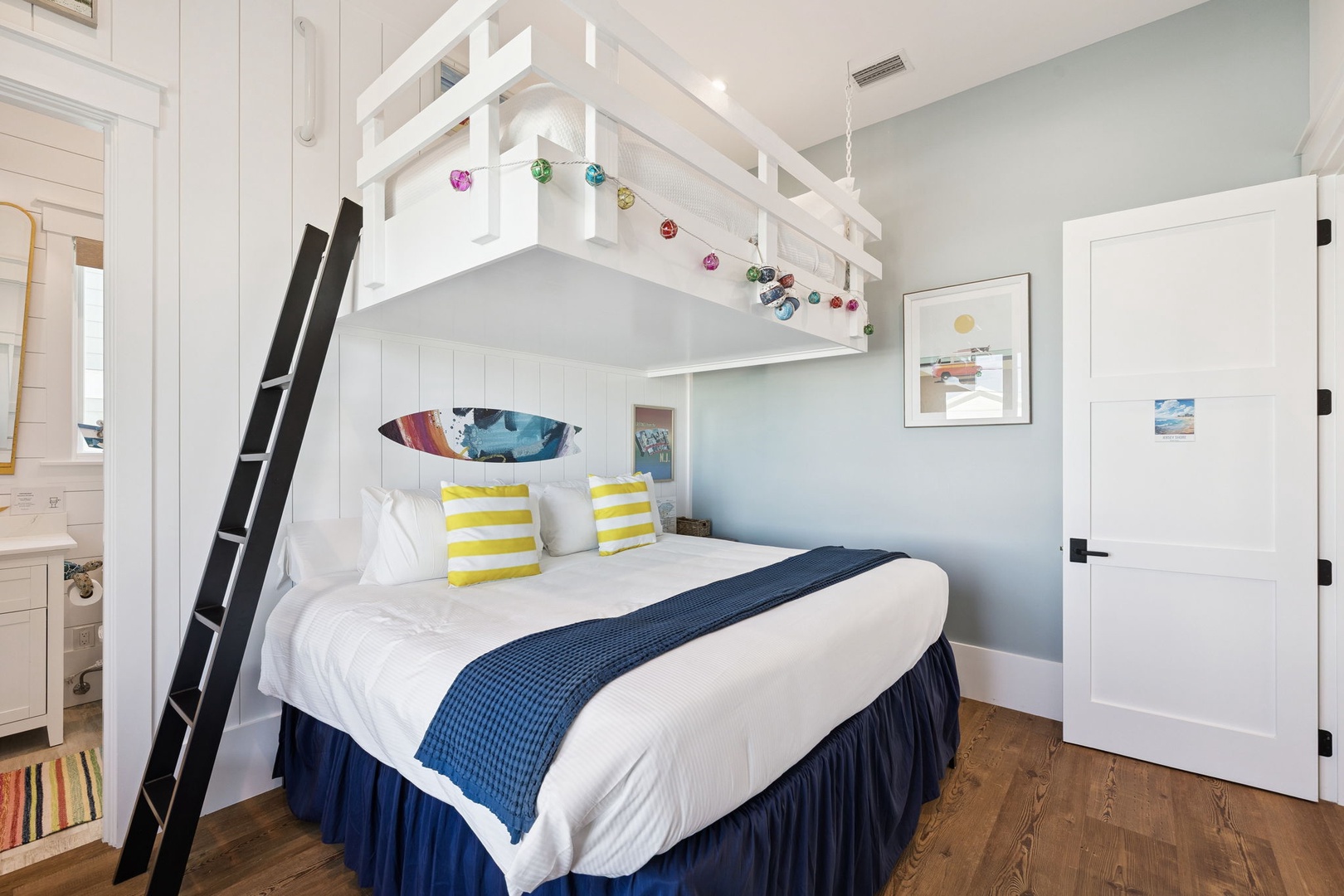 Your coastal retreat features a charming bunk bed setup with nautical touches and cheerful yellow accents for a perfect seaside getaway.