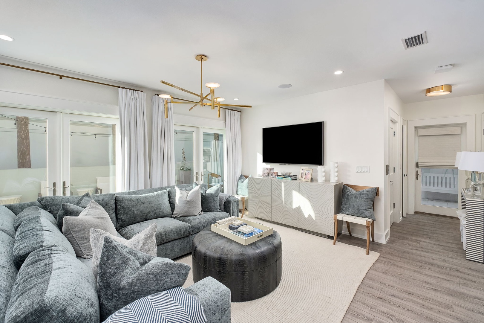 Sink into plush charcoal sofas and unwind in your bright, airy living space, complete with modern lighting, a large flat-screen TV, and seamless access to bedrooms.