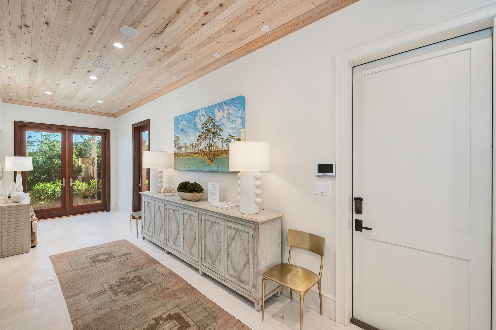 Step through the door into your serene private retreat, where warm wood ceilings and coastal artwork set the tone for your relaxing escape.