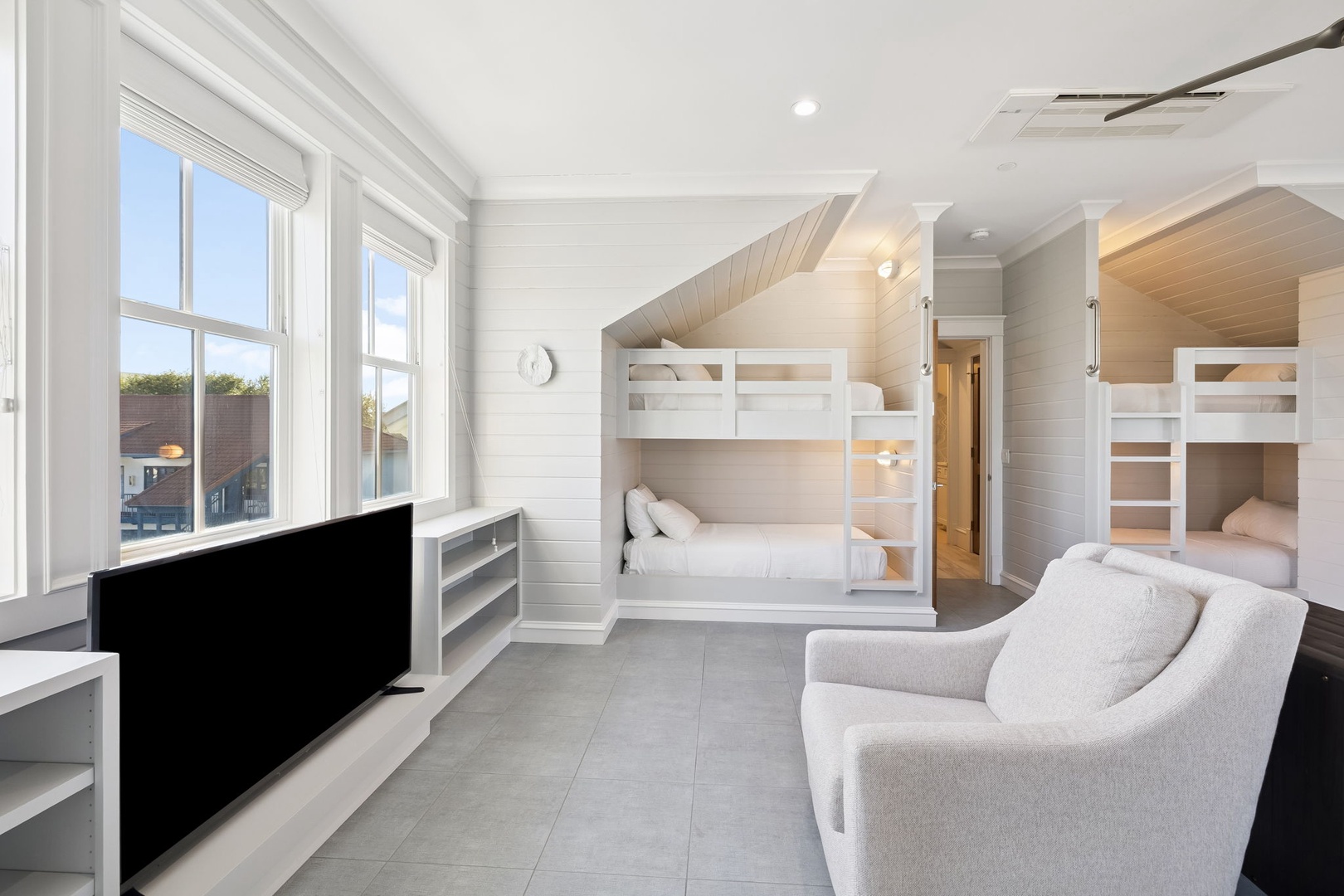 Your stylish room features built-in bunk beds and cozy seating, perfect for families or groups seeking comfort and modern design.