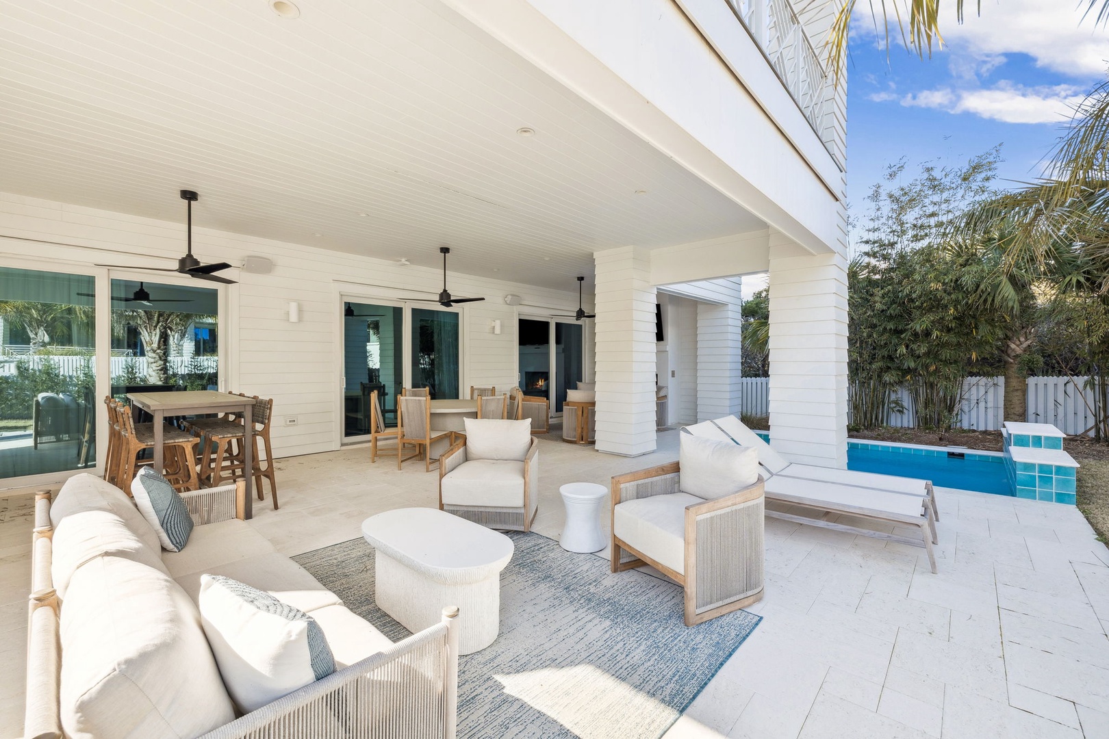 Unwind in your spacious covered terrace where comfort meets tropical elegance, with plush seating overlooking your private pool paradise.