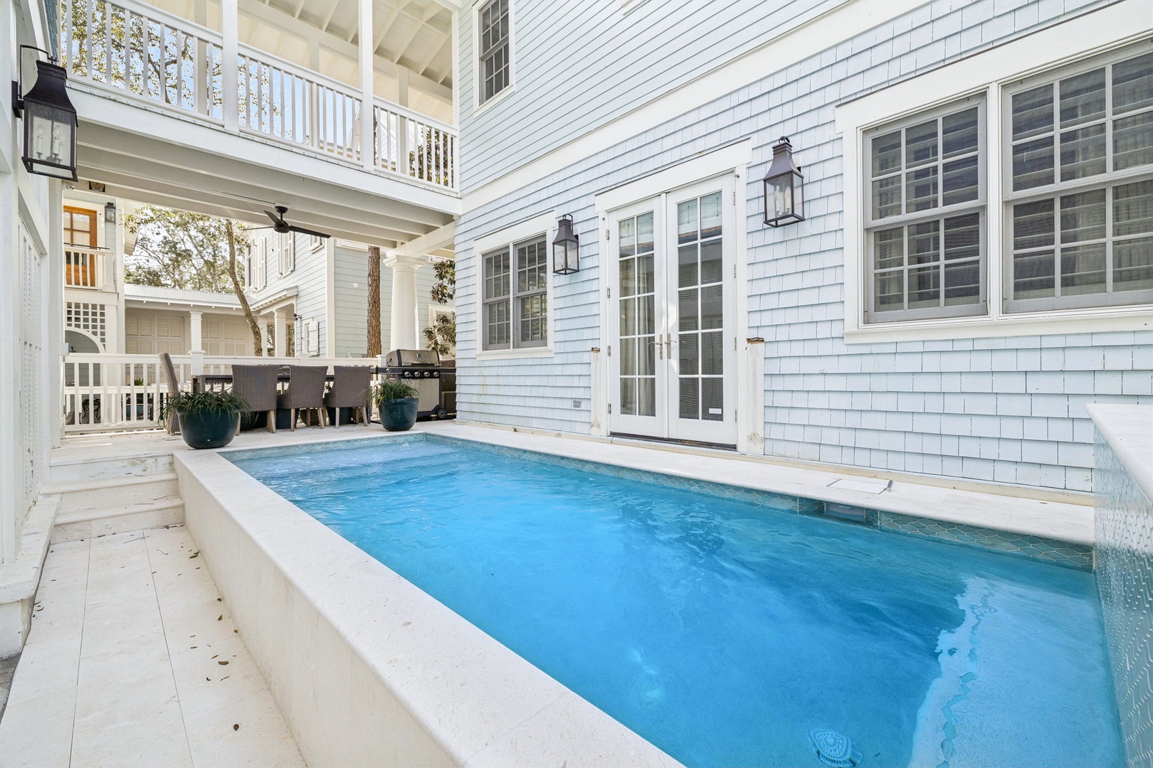 Your private oasis awaits in this stunning courtyard pool, surrounded by elegant architecture and peaceful outdoor living spaces.