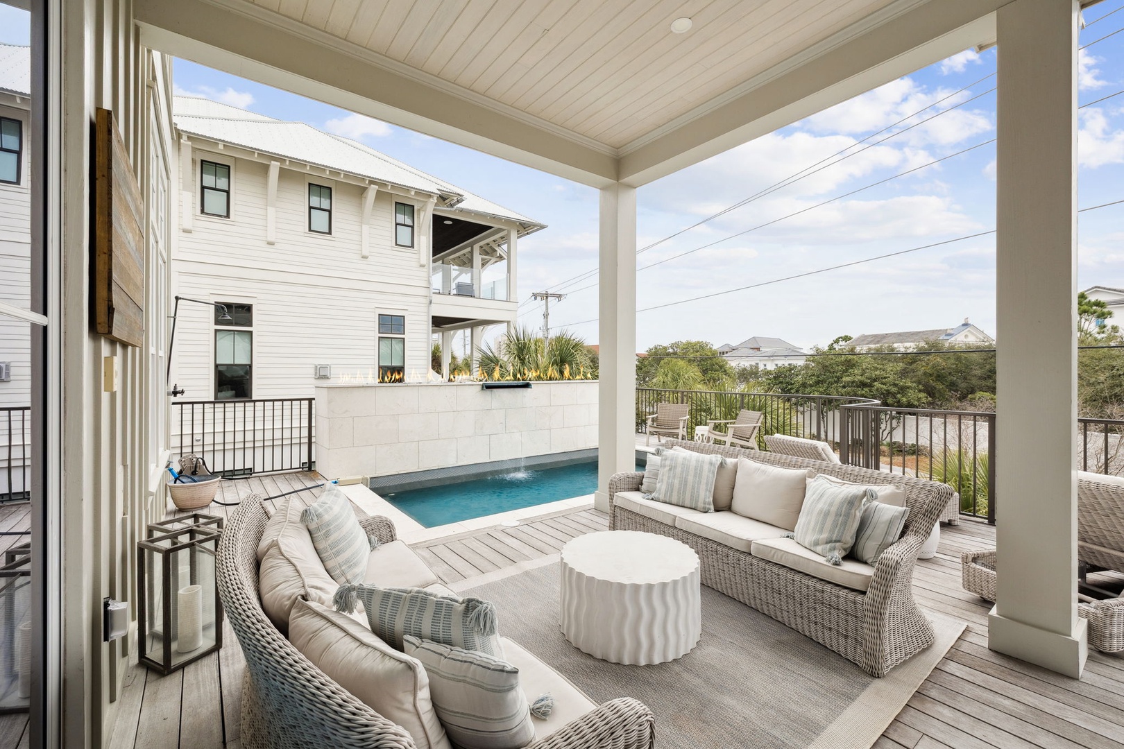 Relax in your private covered terrace overlooking the sparkling pool, where coastal breezes and comfortable seating create the perfect retreat.