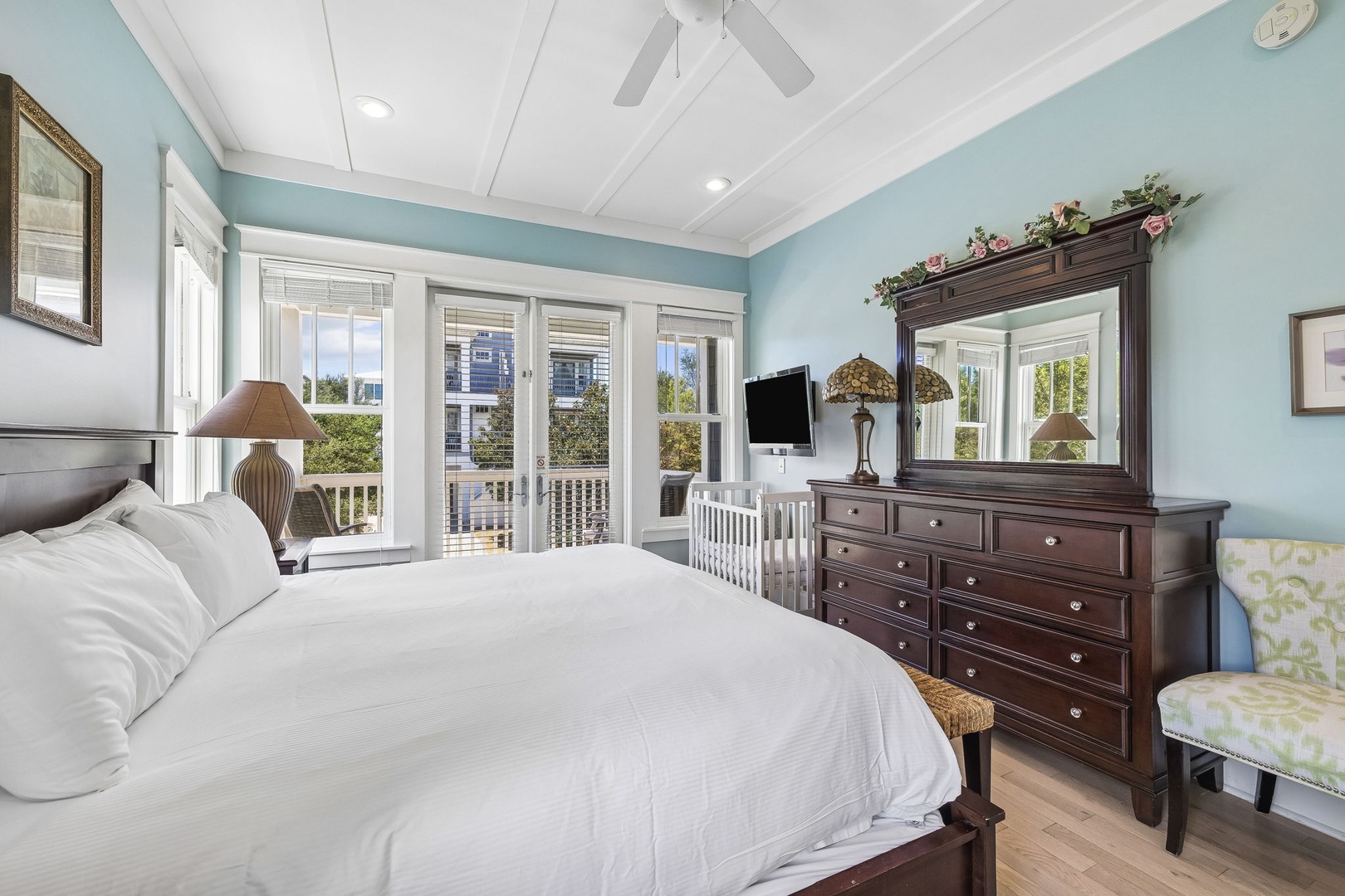 Sink into crisp white linens and let coastal breezes drift through your private balcony doors. The soothing palette and elegant furnishings create your perfect retreat after beach days.