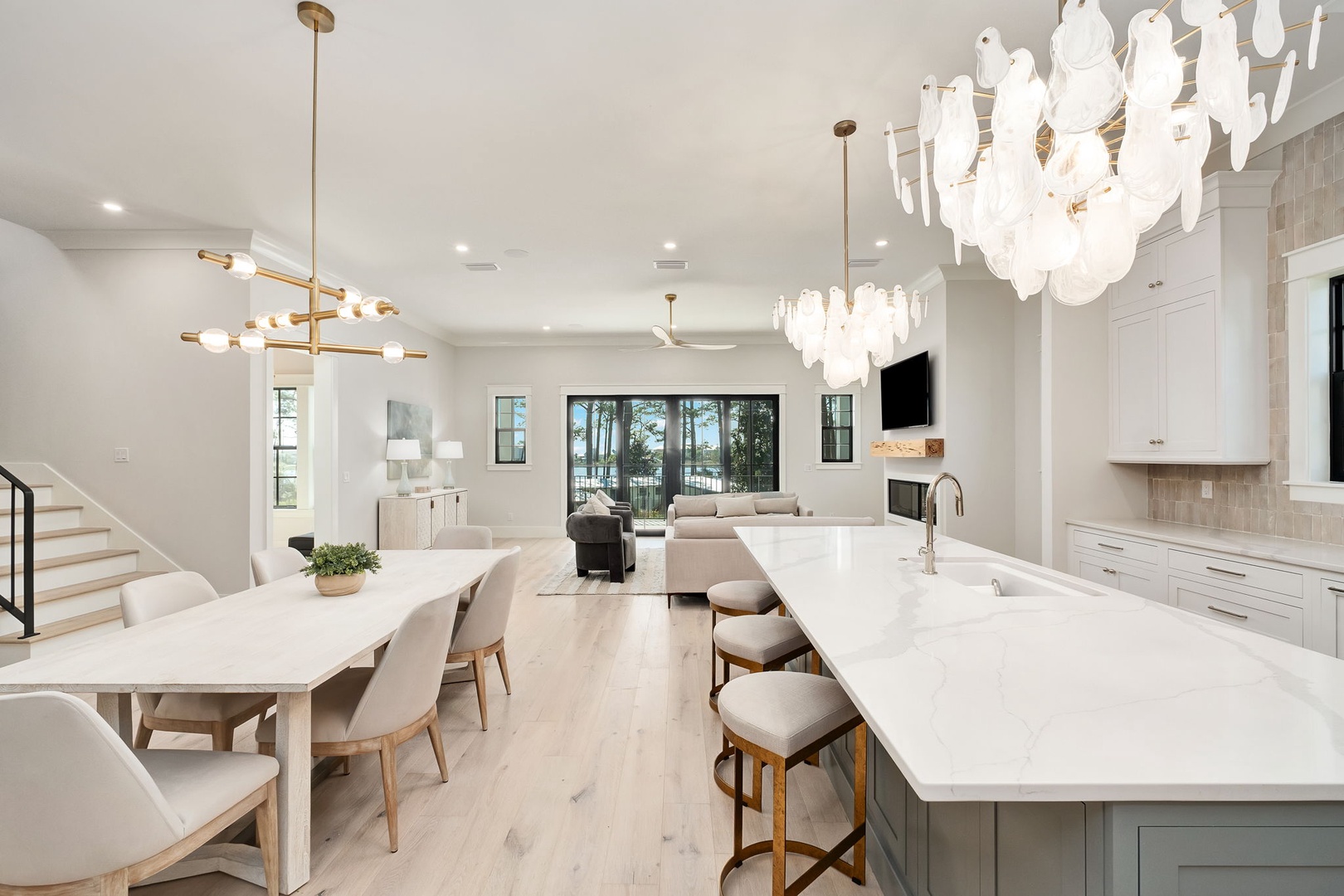 Your gourmet kitchen flows seamlessly into the dining area, where stunning chandeliers illuminate intimate dinners and morning coffee moments together.
