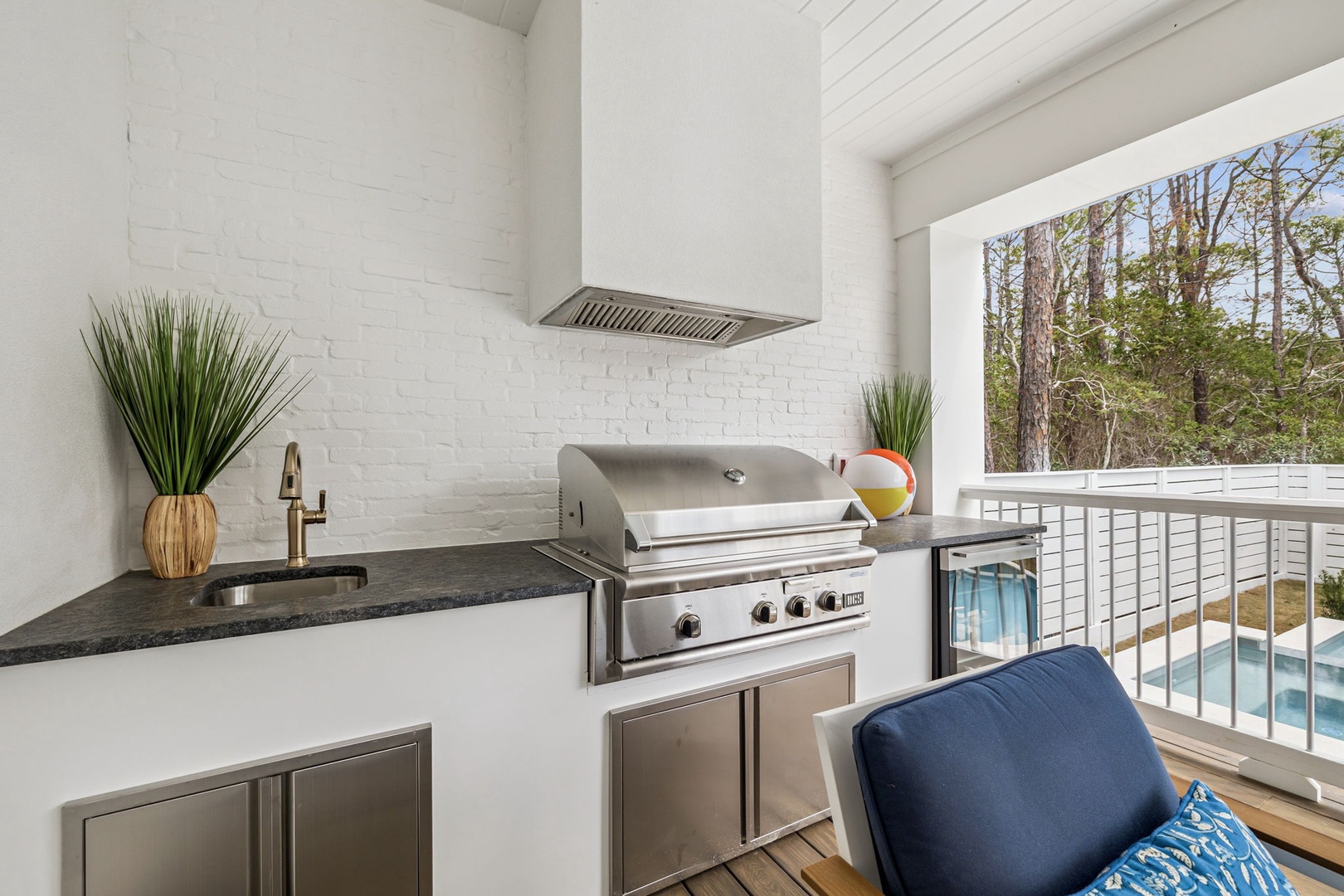 Your private balcony kitchen lets you grill while enjoying pool views through the trees—perfect for outdoor entertaining.