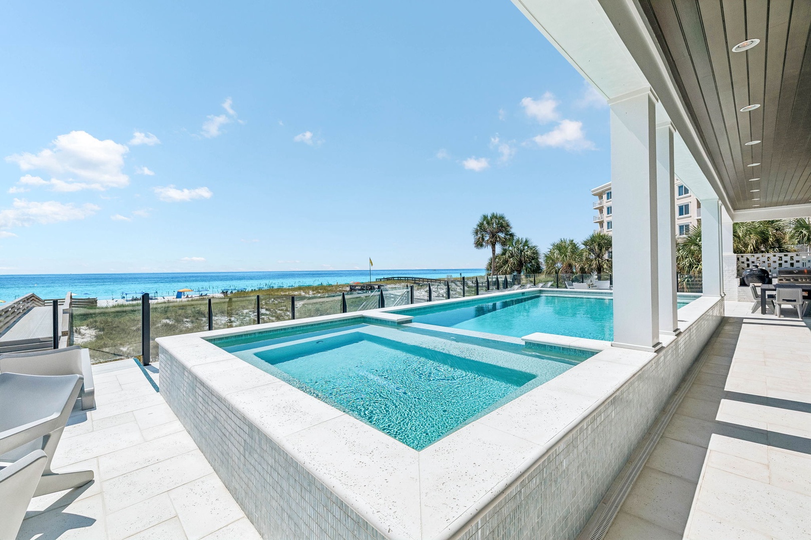Soak in stunning turquoise waters stretching to the horizon as you lounge by your private pool and hot tub, just steps from pristine white sand.