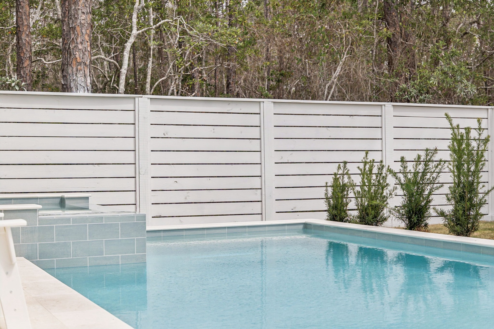 Dive into crystal-clear waters surrounded by natural bushland, where your private oasis awaits with elegant tiling and complete privacy.