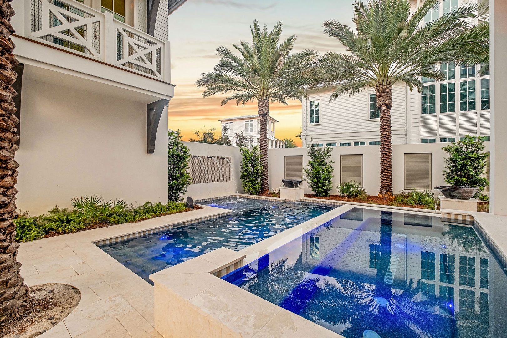 Your private oasis awaits with a stunning pool framed by swaying palms and lush landscaping, perfect for unwinding after a sun-soaked day.