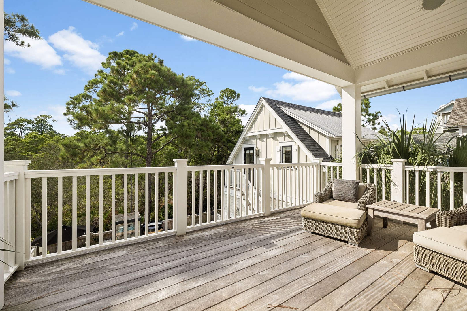 Step outside to your spacious private deck, where plush seating invites you to unwind under the sheltered ceiling. Surrounded by lush greenery and tranquil views, it's the perfect spot for morning coffee or evening conversations.