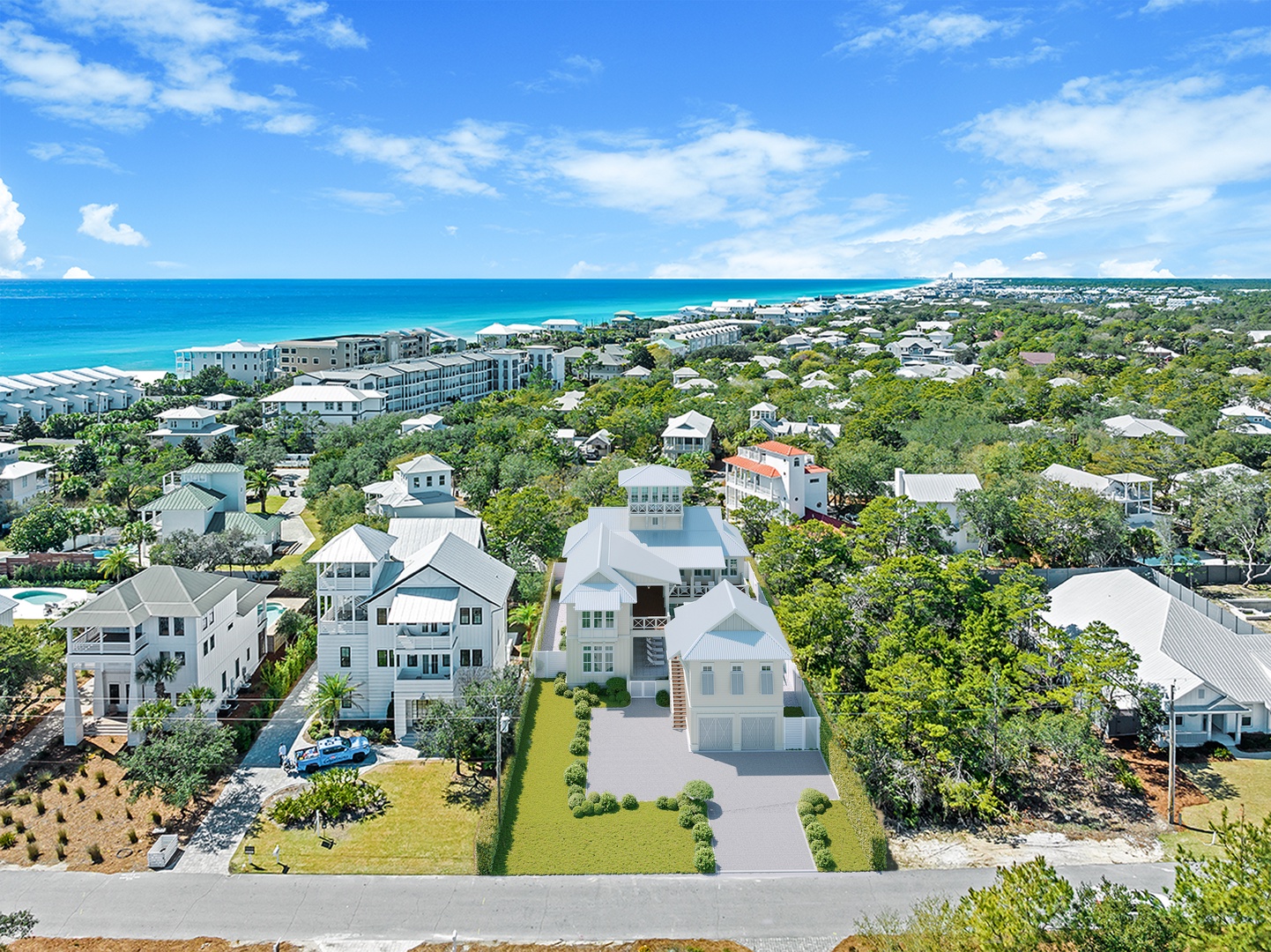 Aerial view of a coastal vacation community, showcasing the property nestled among lush greenery with the turquoise Gulf waters and white sandy beaches nearby.
