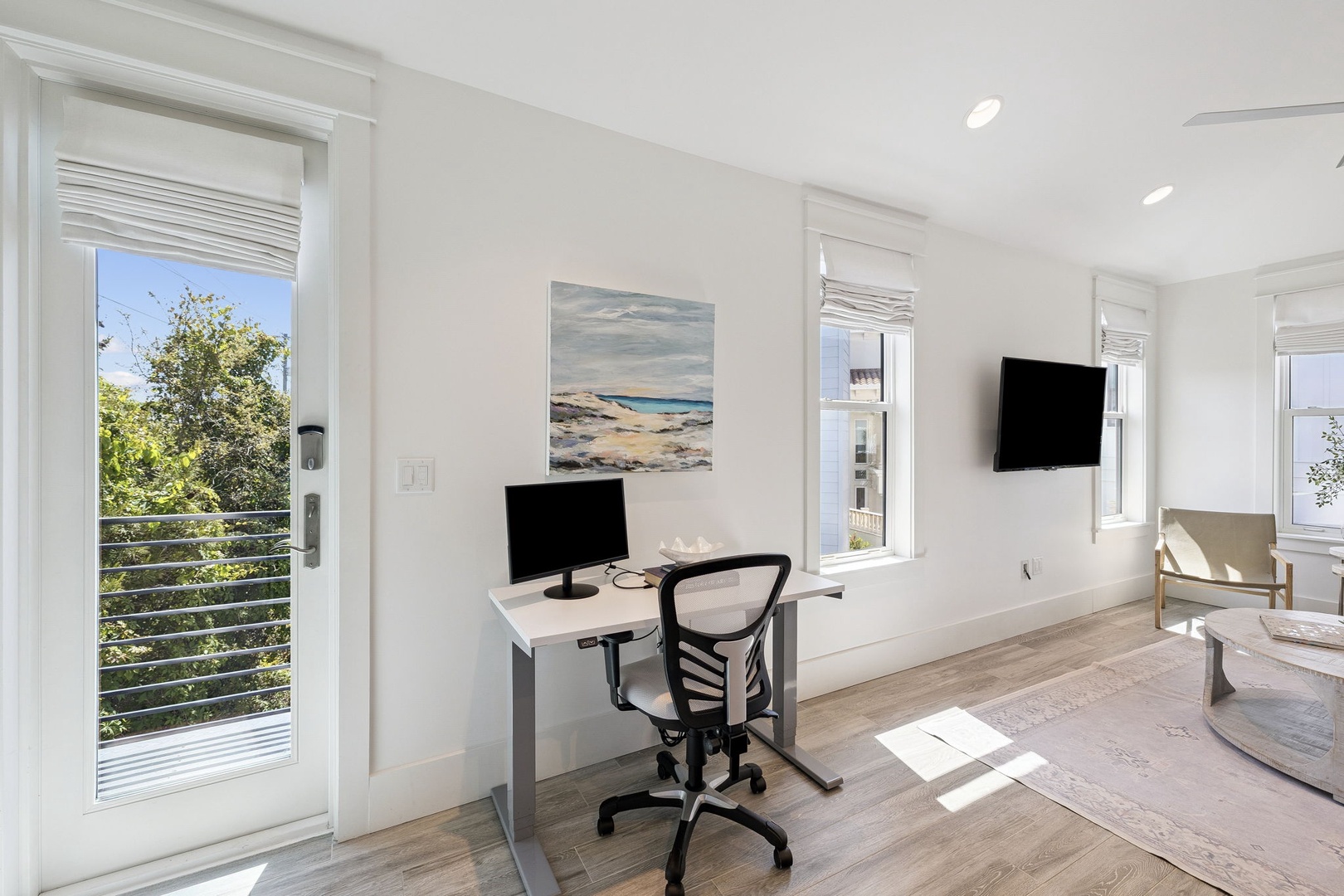 Your bright workspace overlooks peaceful greenery through French doors that open to a private balcony, creating the perfect blend of productivity and tranquility.