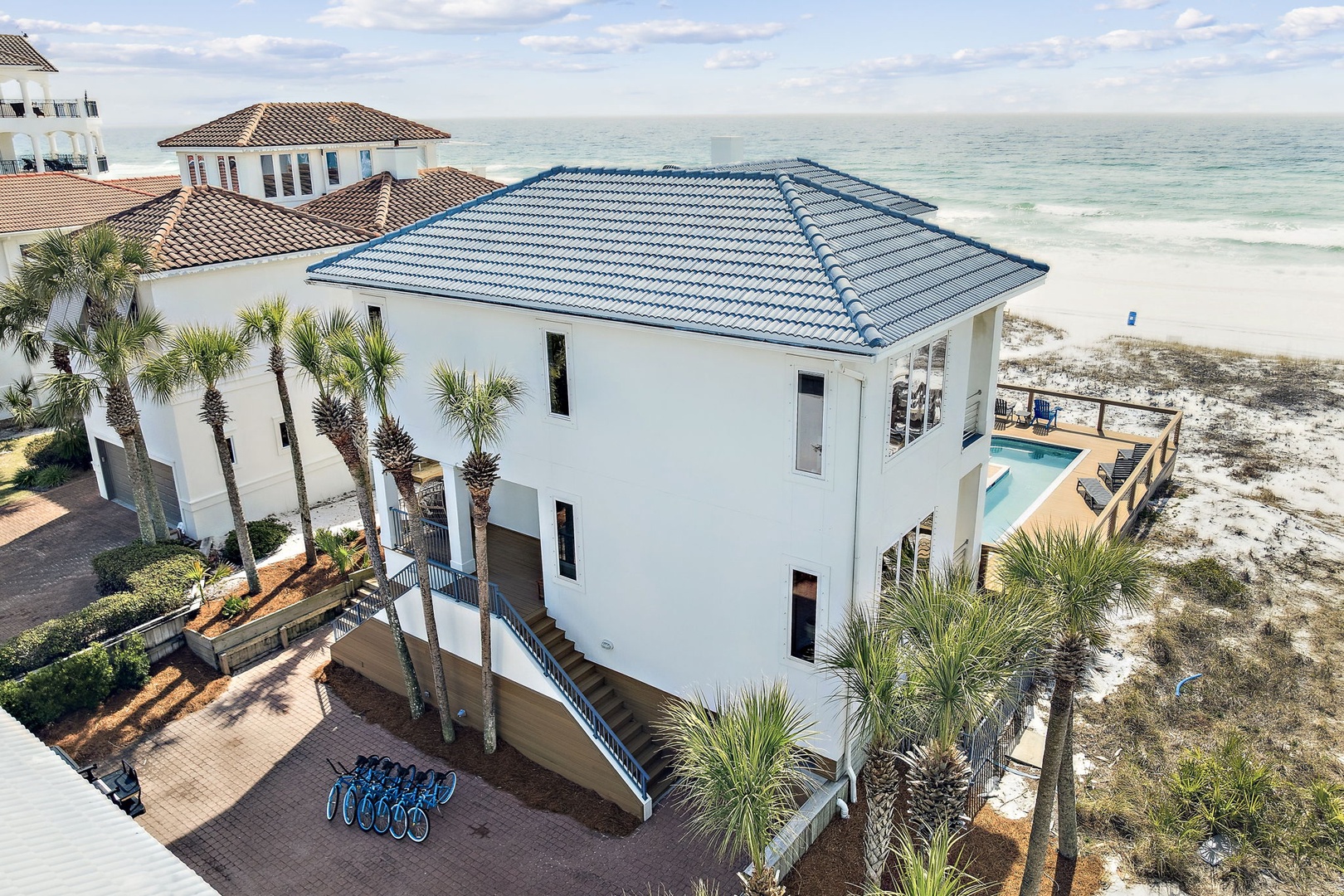 Stunning beachfront home sits directly on pristine white sand, offering unparalleled ocean access and coastal luxury.