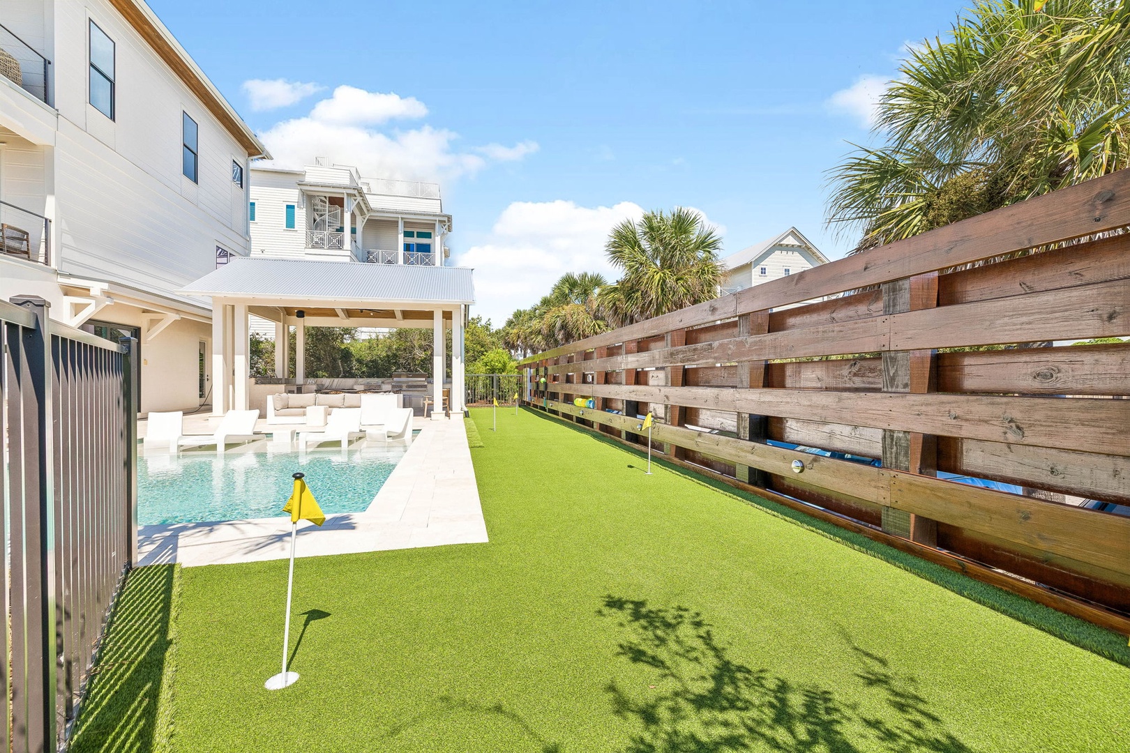 Practice your putting game on your private backyard mini-golf green, then cool off with a dip in the sparkling pool—perfect for fun and relaxation under sunny skies.