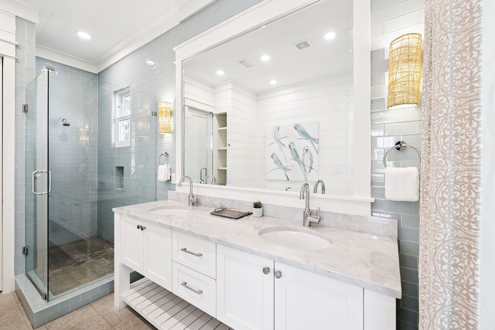 Indulge in your private spa-like retreat with marble countertops, glass shower, and elegant coastal touches that make every morning feel luxurious.