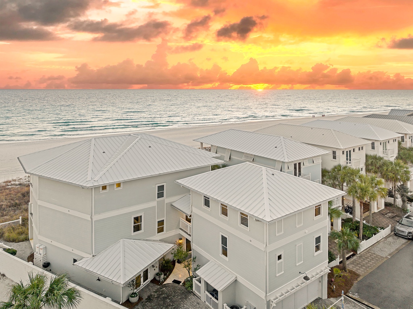 Beachfront property featuring pristine white sand, direct ocean access, and stunning coastal sunsets along the shoreline.
