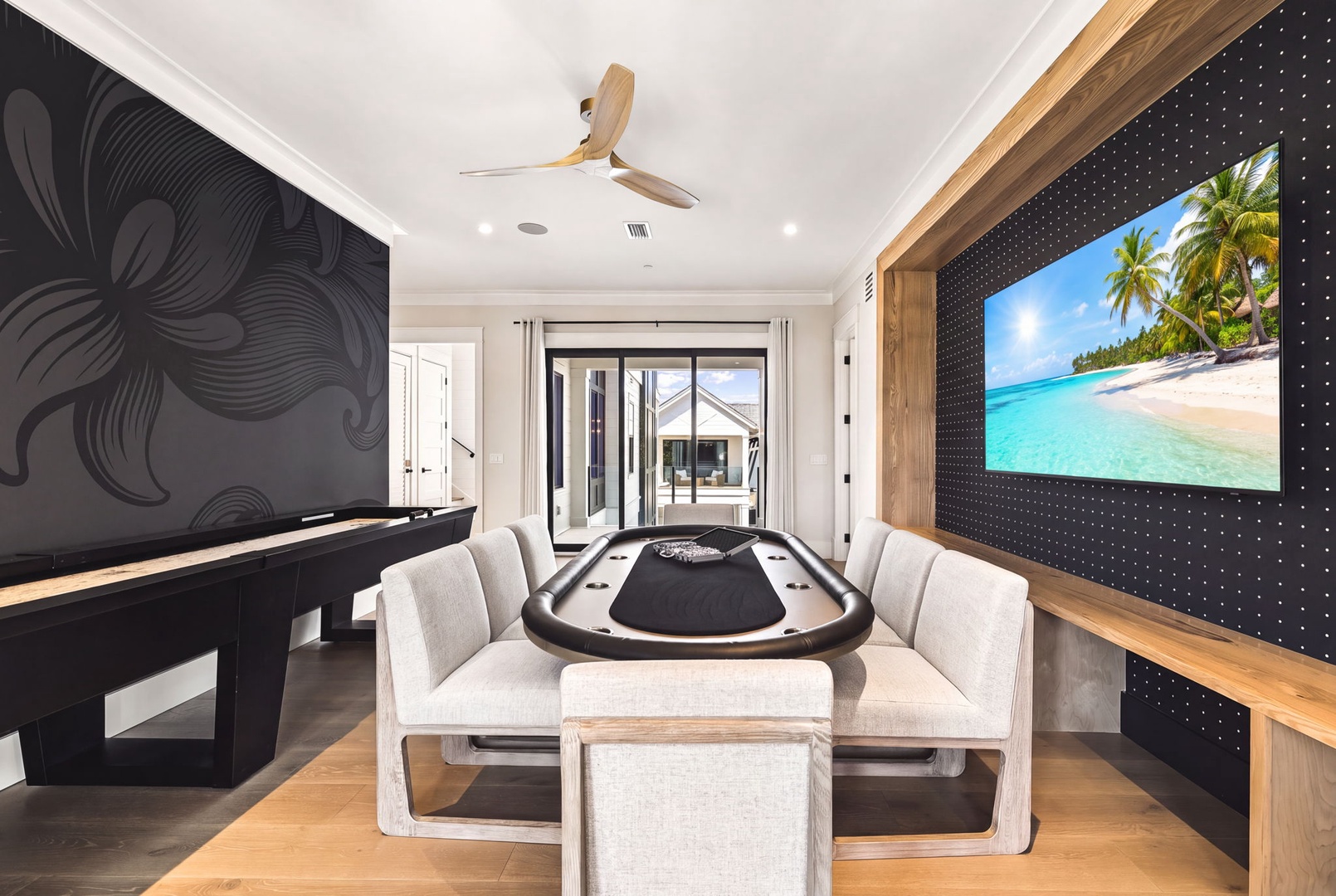 Your private game room invites friendly competition with a custom poker table and entertainment setup, all under warm wood-toned accents and modern décor.