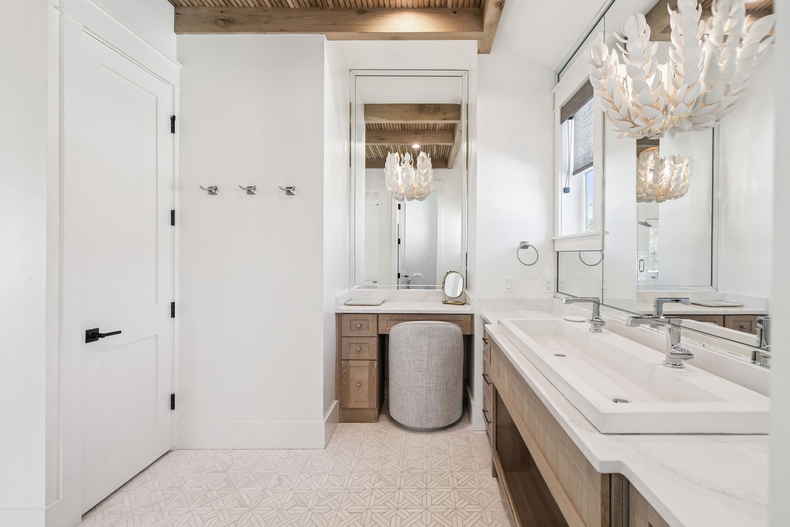 Pamper yourself in this spa-like bathroom with stunning chandeliers, luxurious vanity seating, and elegant finishes that make your morning routine feel indulgent.