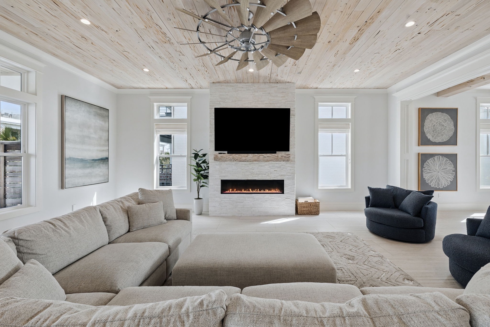 Sink into plush seating beneath soaring wood-beamed ceilings, where your cozy fireplace creates the perfect ambiance for relaxing evenings together.