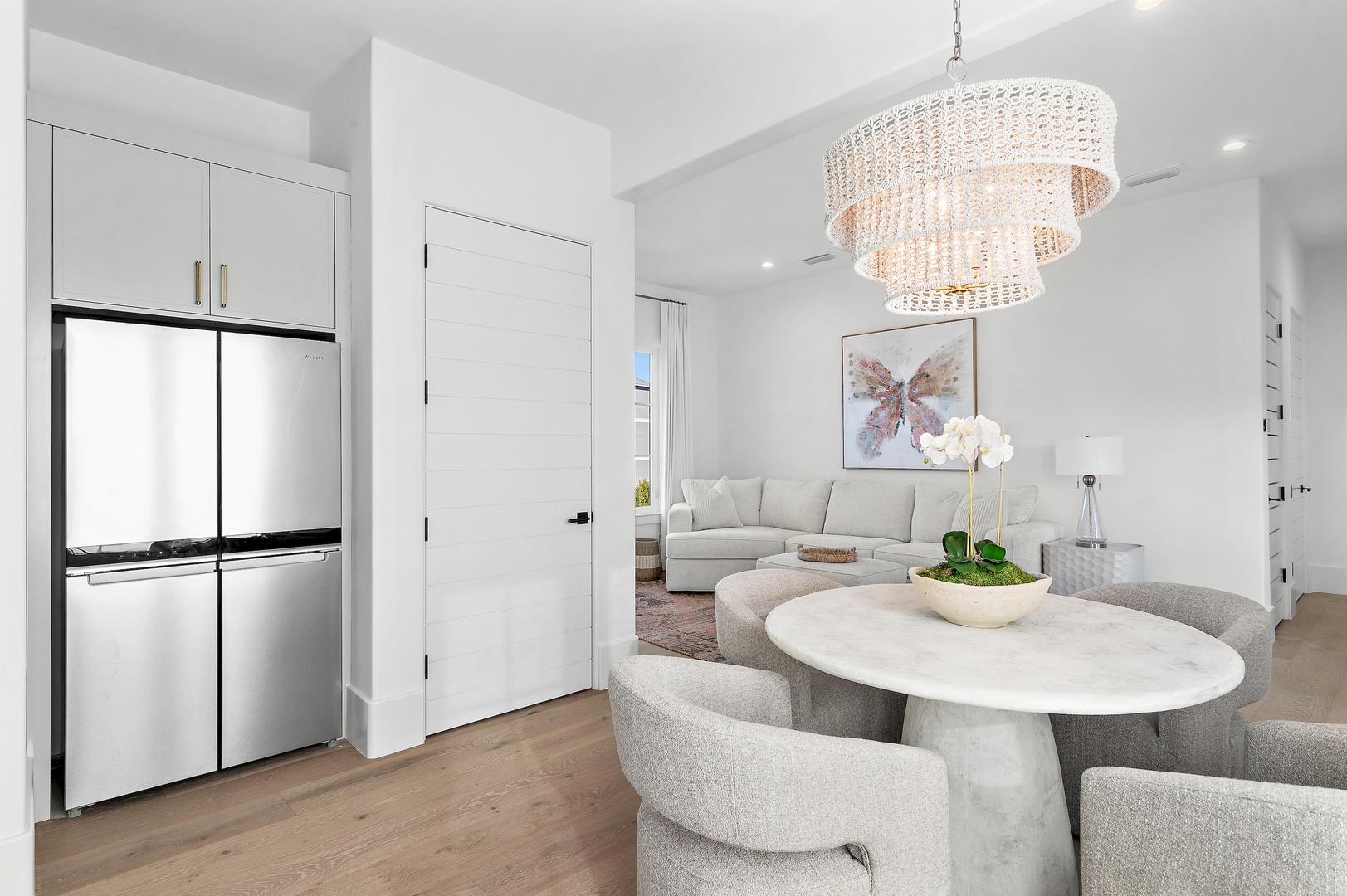 A stunning crystal chandelier anchors your open-concept space, where plush seating and modern elegance create the perfect atmosphere to unwind after exploring the area.