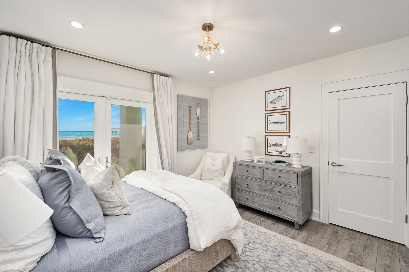 Wake up to stunning ocean breezes and turquoise views from your tranquil bedroom retreat. Coastal artwork and soft linens invite you to unwind in this peaceful sanctuary.