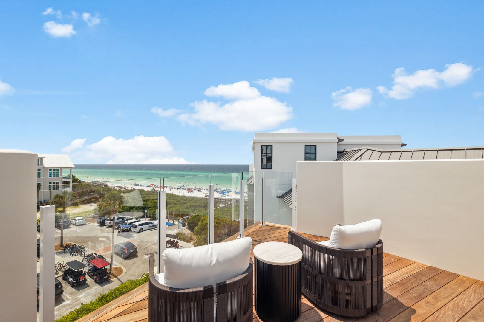 Unwind in plush seating on your private rooftop terrace, where turquoise gulf waters and soft sandy shores create a stunning coastal backdrop for your vacation.