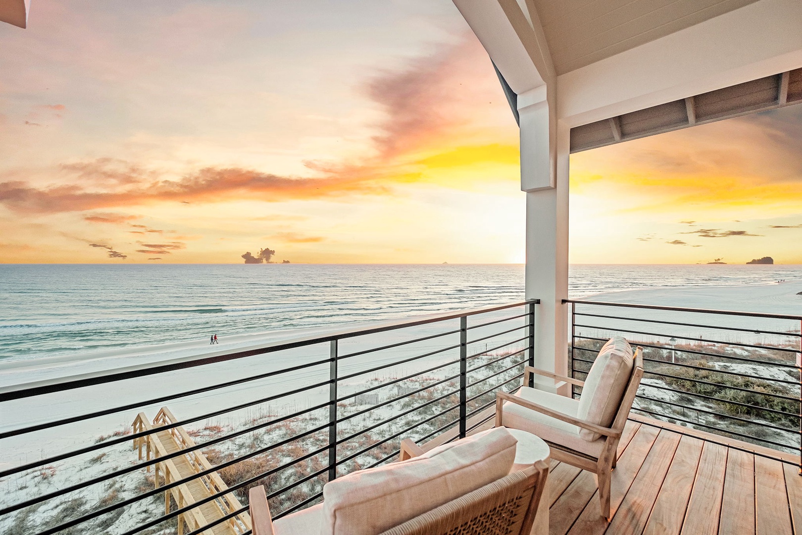 Wake up to breathtaking sunsets from your private balcony, where comfortable seating awaits your evening relaxation overlooking pristine ocean waters.