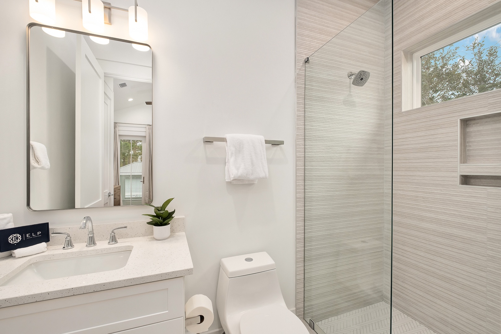 Step into your spa-like bathroom with sleek marble finishes, a spacious walk-in shower, and fresh towels waiting for your arrival.