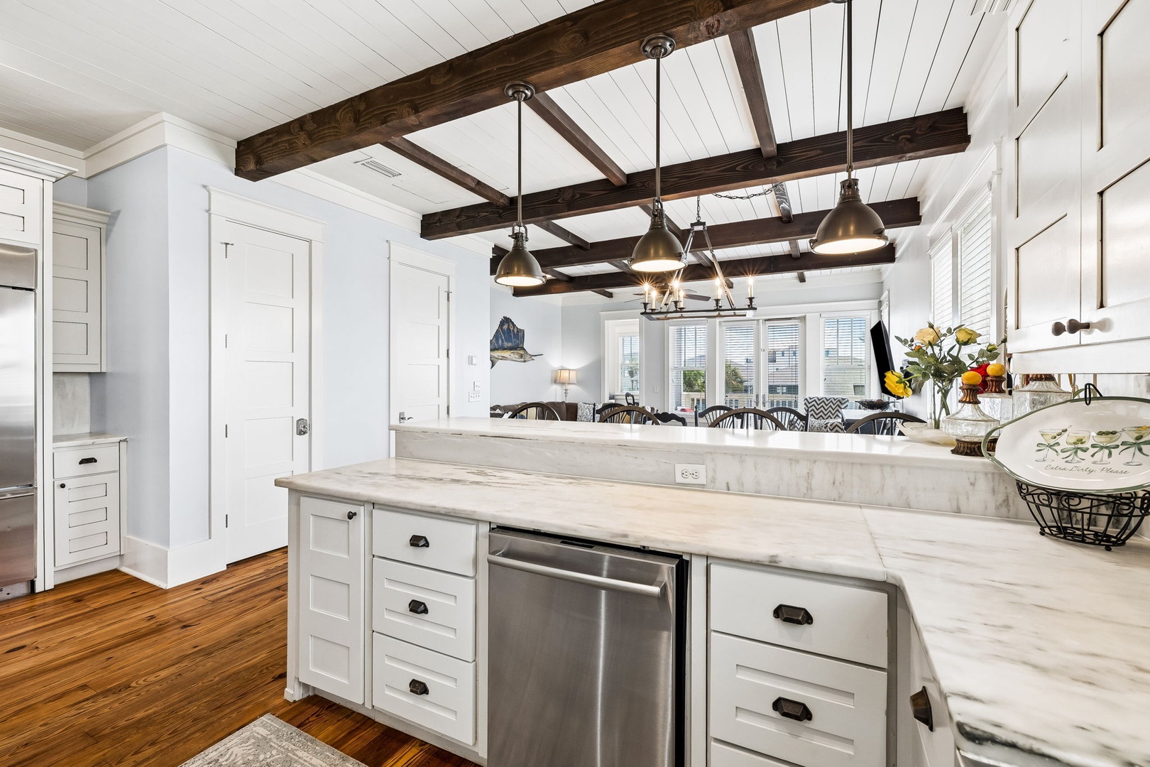 Your spacious kitchen welcomes you with a stunning marble island, rustic wood beams overhead, and stainless steel appliances—perfect for gathering and creating meals together during your stay.