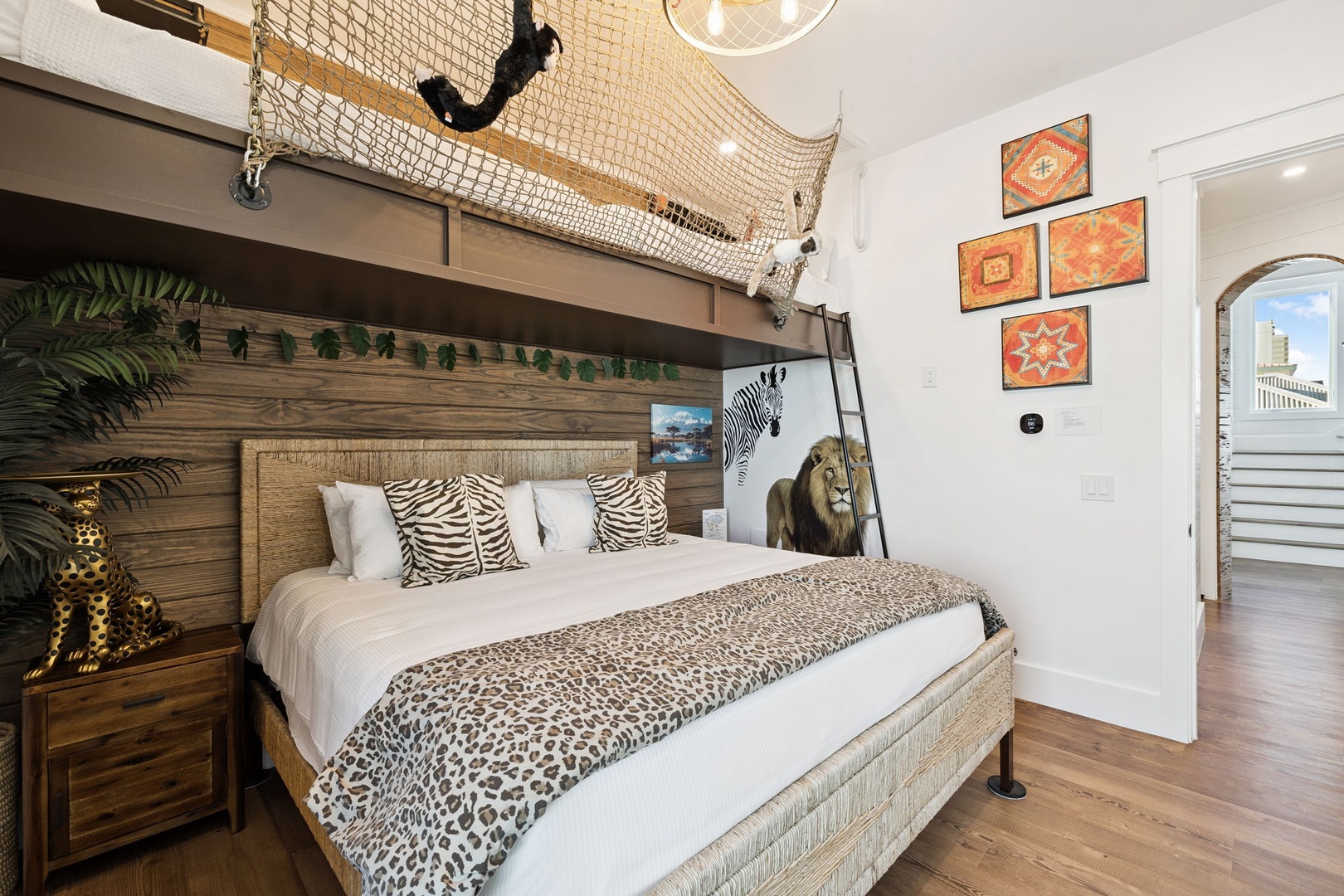 Your adventure-themed bedroom features a playful loft with safari-inspired decor and cozy animal print bedding for a wild night's sleep.