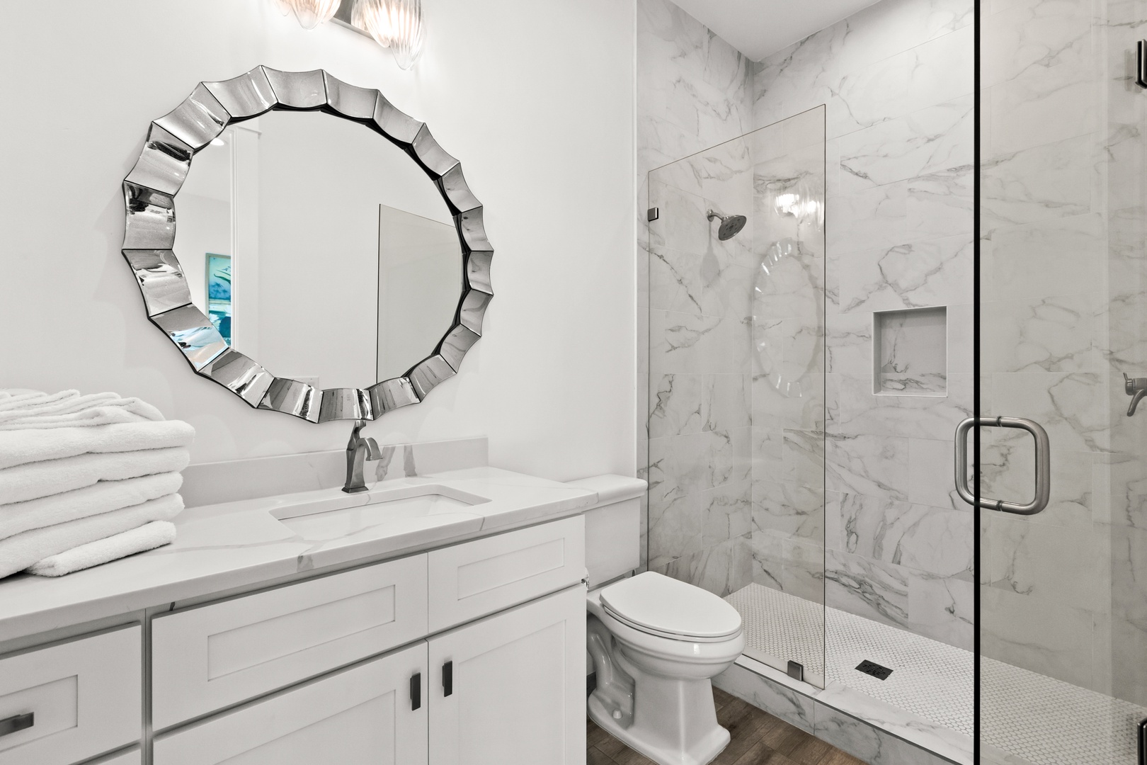 Step into this luxurious marble bathroom, where crisp white tones meet elegant design. Relax under the rain showerhead and enjoy plush towels waiting for you.