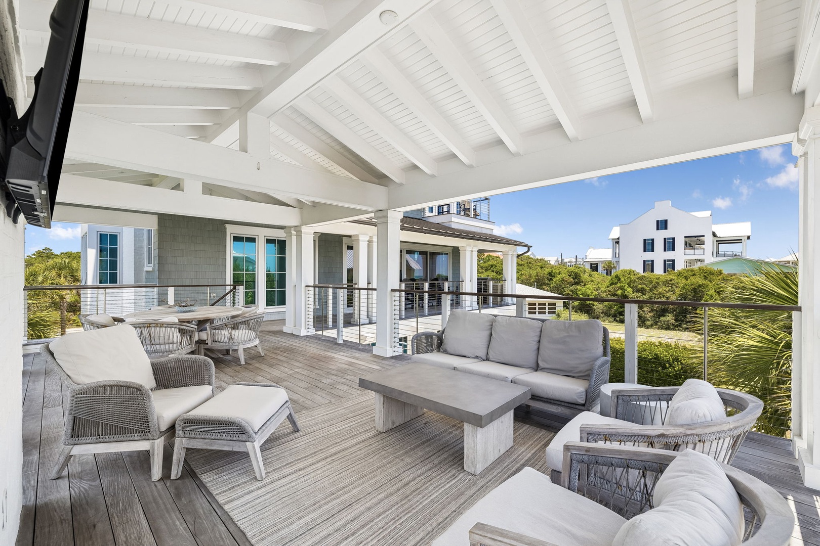 Relax in your private covered terrace with plush seating, a sleek fire pit, and coastal breezes—perfect for morning coffee or sunset gatherings.