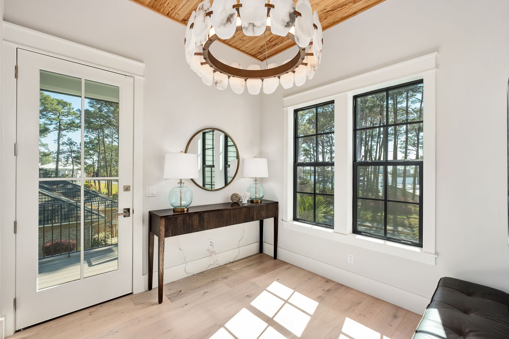 Relax in this bright corner nook where natural light streams through large windows, perfect for morning coffee or quiet moments.